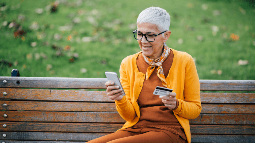 Senior women with phone and credit card